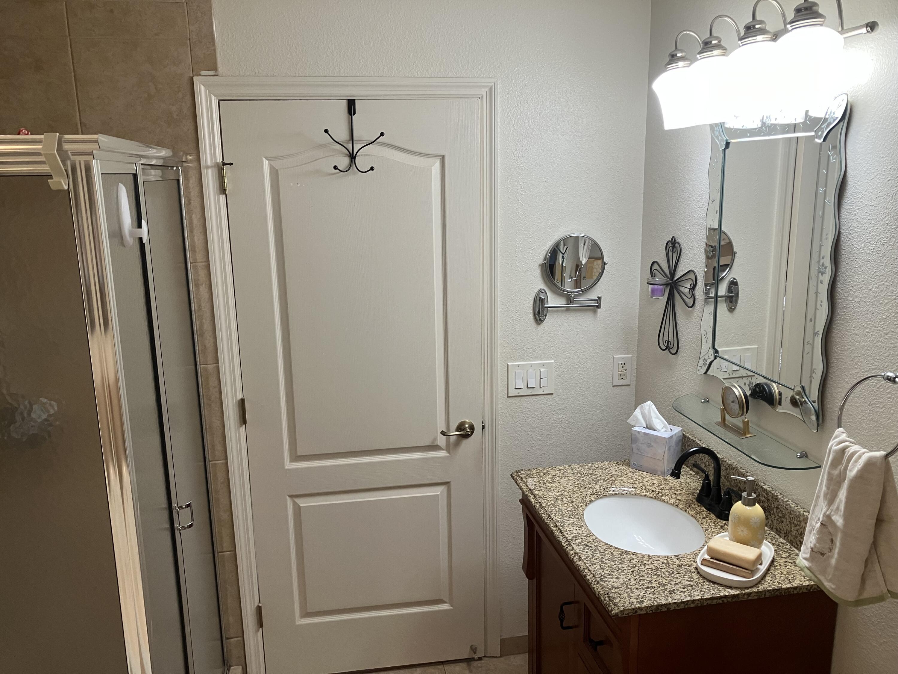 14050 Brighton Street Spring Hill, FL 34609 - Photo 12 of 20 a bathroom with a granite countertop sink toilet and shower