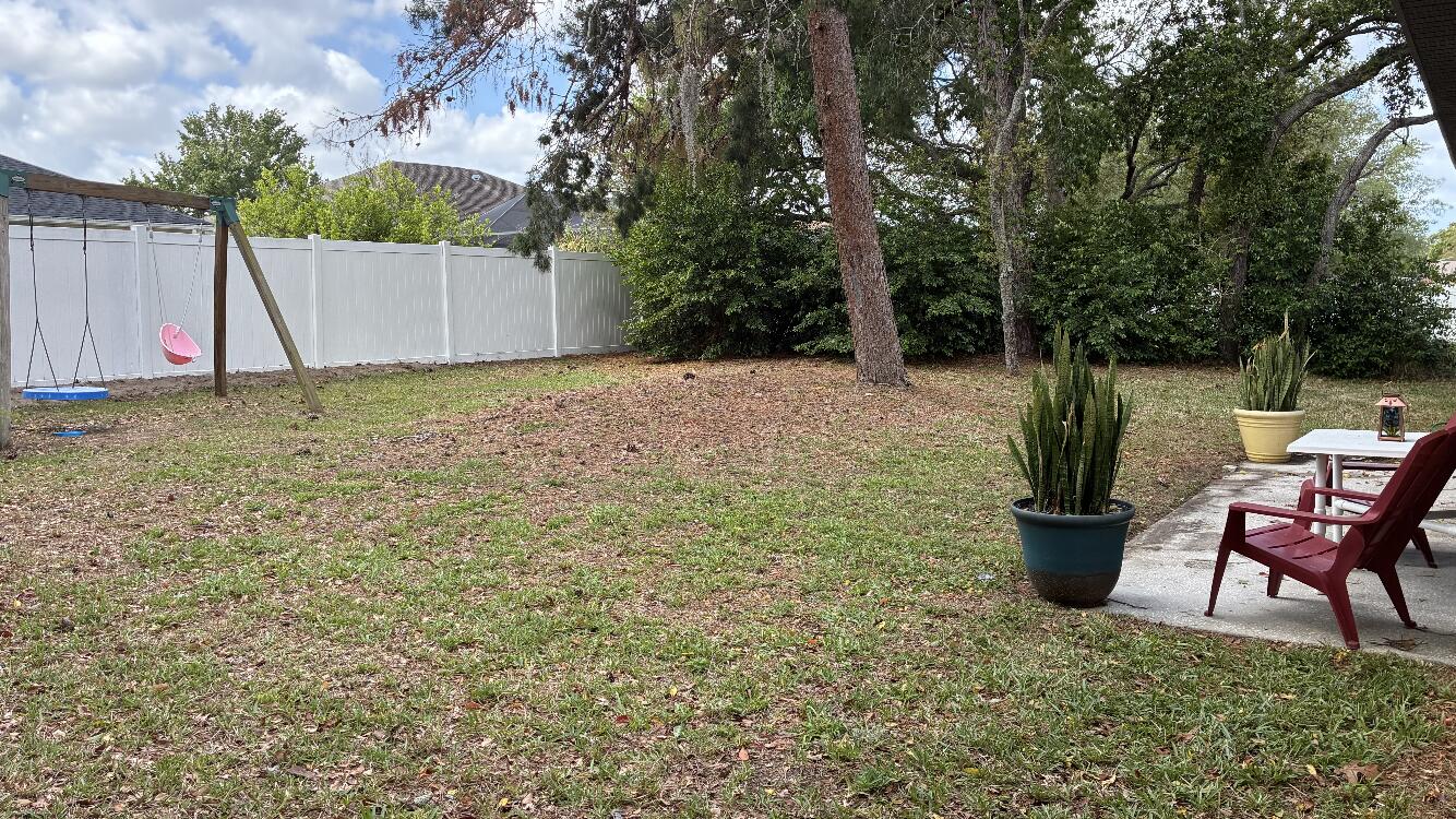 14050 Brighton Street Spring Hill, FL 34609 - Photo 18 of 20 a view of a backyard with furniture and a tub