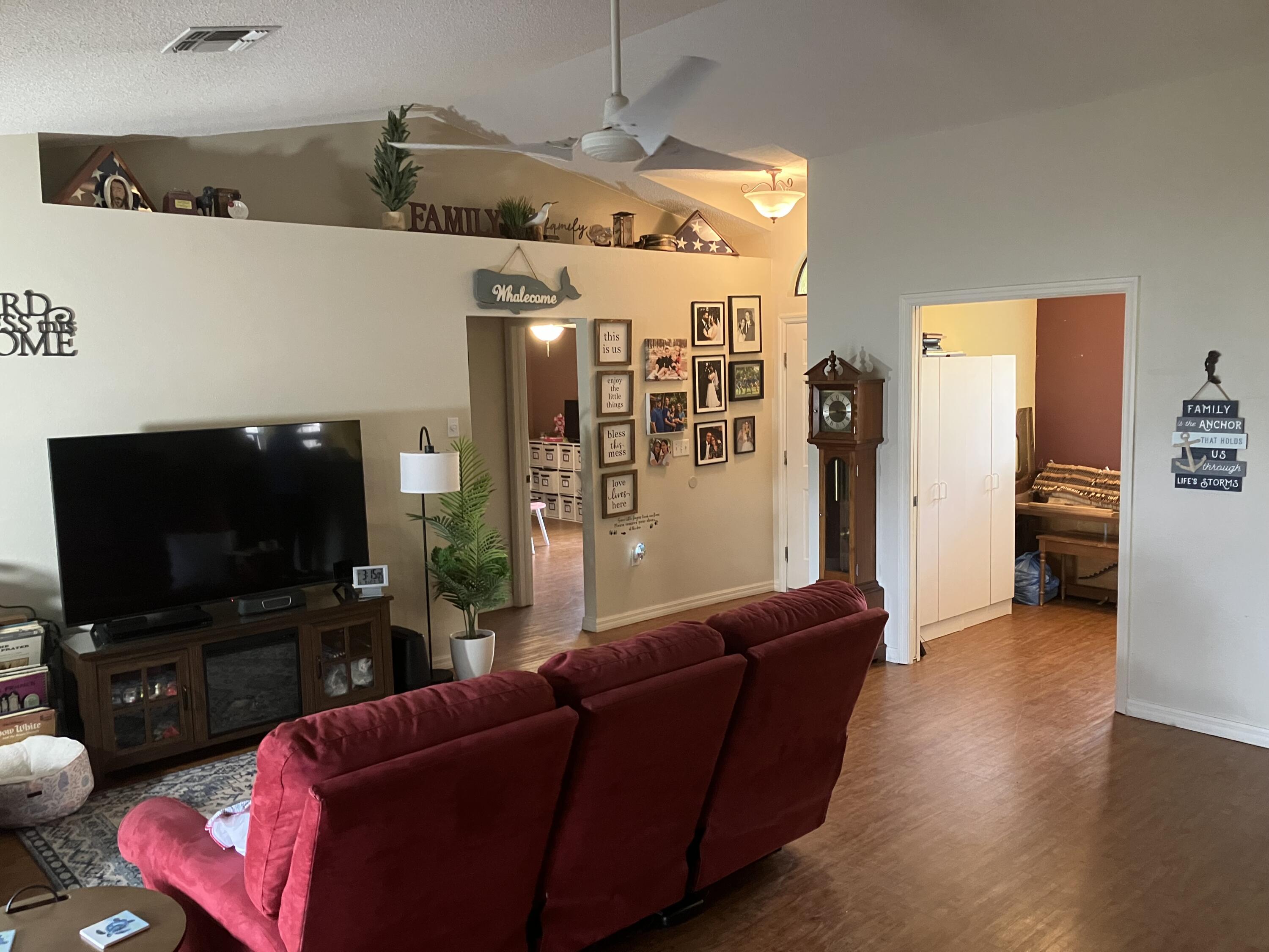 14050 Brighton Street Spring Hill, FL 34609 - Photo 2 of 20 a living room with furniture and a flat screen tv
