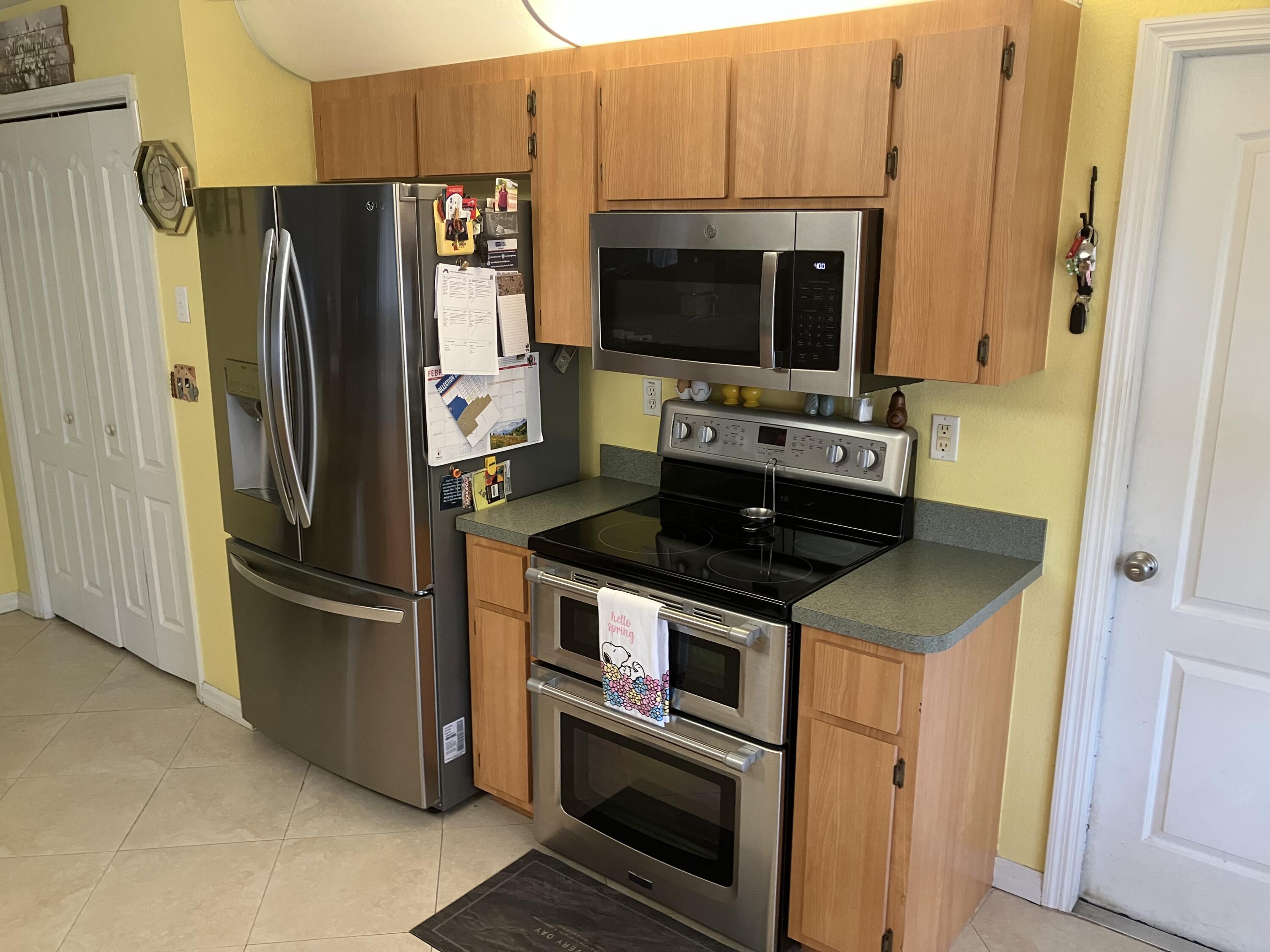 14050 Brighton Street Spring Hill, FL 34609 - Photo 7 of 20 a kitchen with stainless steel appliances and a refrigerator