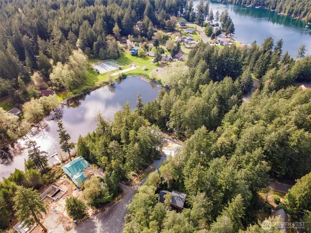 an aerial view of residential houses with outdoor space and trees