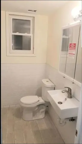 a bathroom with a sink toilet and mirror