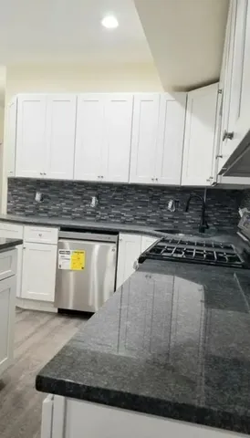 a view of a kitchen with an empty space and a stove top oven