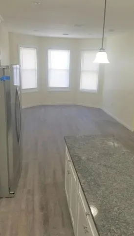 a bathroom with a granite countertop sink and shower