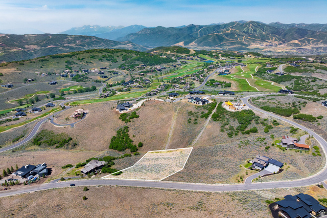 3508 Ridgeway Drive, Unit 31 Heber City, UT 84036 - Photo 1 of 13 Expansive hillside parcel featuring a mountain backdrop, a paved road frontage, and surrounding residential properties