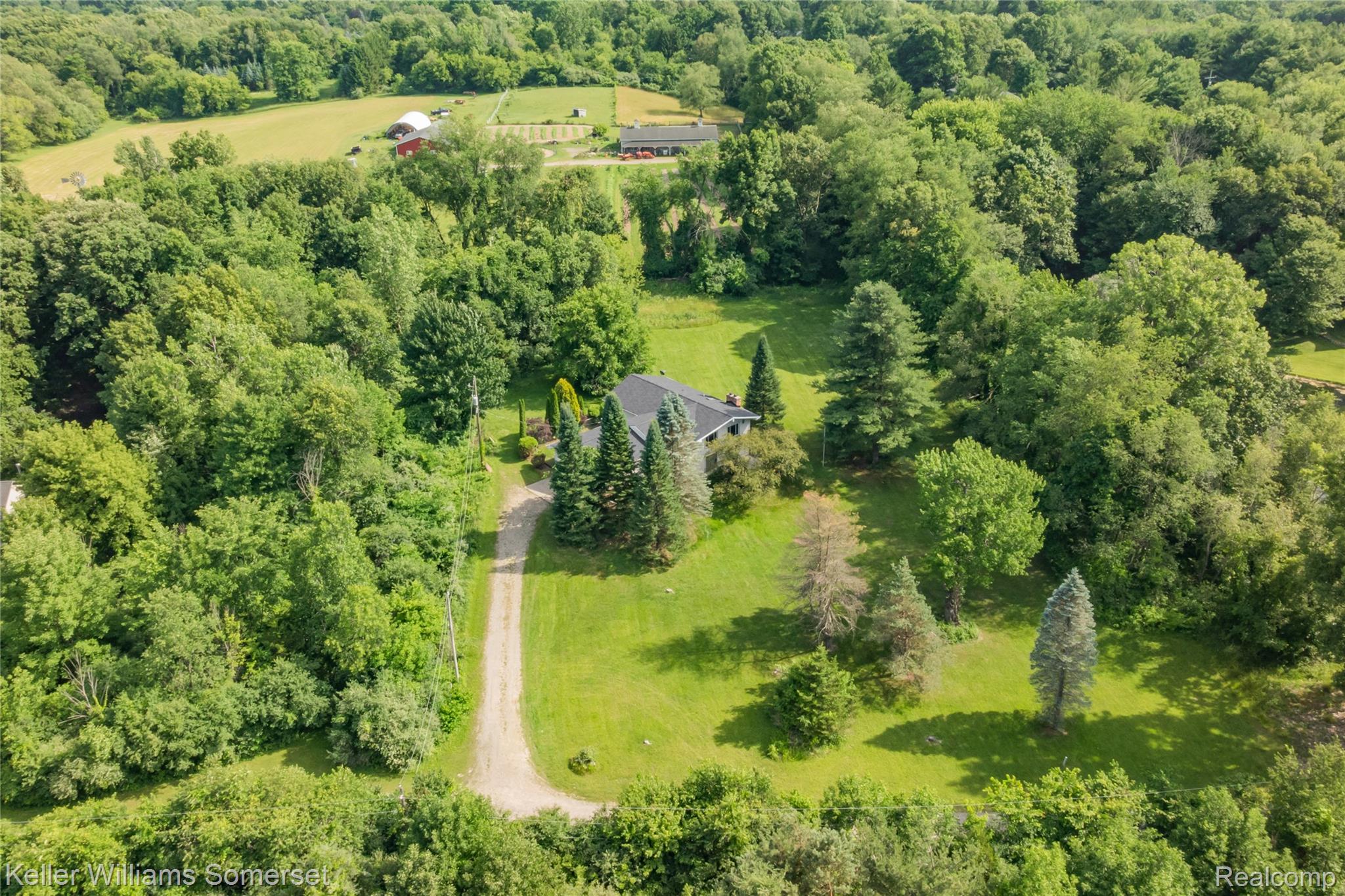 2344 Rochester Road Leonard, MI 48367 - Photo 62 of 66 Expansive property featuring a gravel driveway, mature trees, manicured lawns, and a private setting