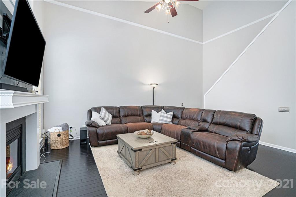 9379 Hillston Ridge Road Huntersville, NC 28078 - Photo 13 of 38 a living room with furniture a flat screen tv and a fireplace