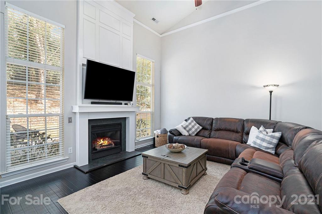 9379 Hillston Ridge Road Huntersville, NC 28078 - Photo 14 of 38 a living room with furniture a flat screen tv and a fireplace