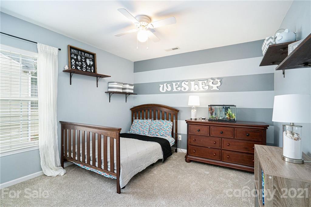 9379 Hillston Ridge Road Huntersville, NC 28078 - Photo 17 of 38 a bedroom with a bed and a lamp on the dresser