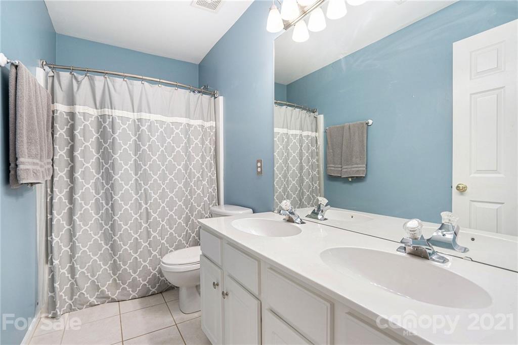9379 Hillston Ridge Road Huntersville, NC 28078 - Photo 19 of 38 a bathroom with a double vanity sink toilet and a mirror