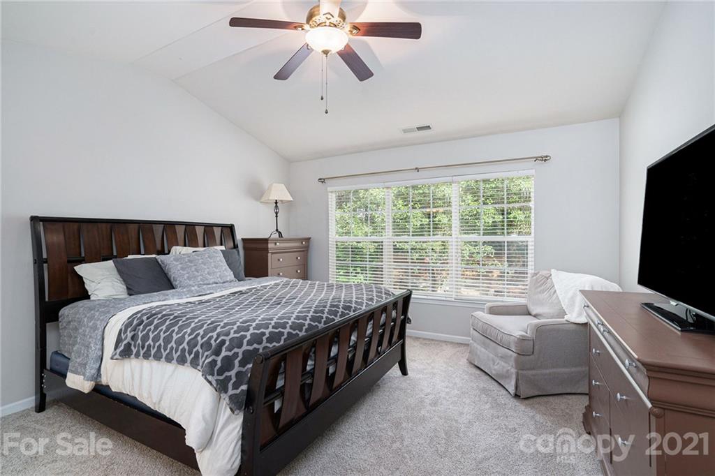 9379 Hillston Ridge Road Huntersville, NC 28078 - Photo 23 of 38 a bedroom with a bed couch and a flat tv screen