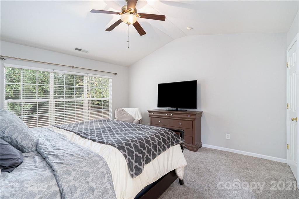 9379 Hillston Ridge Road Huntersville, NC 28078 - Photo 24 of 38 a bedroom with a bed and a flat screen tv