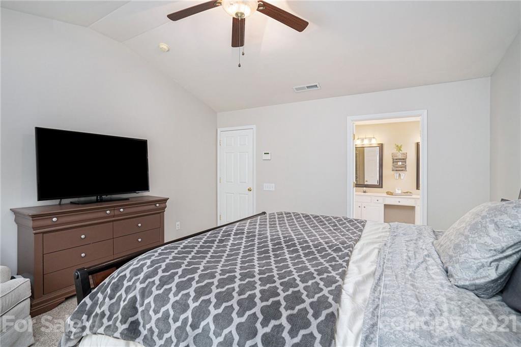 9379 Hillston Ridge Road Huntersville, NC 28078 - Photo 25 of 38 a bedroom with a bed and a flat screen tv