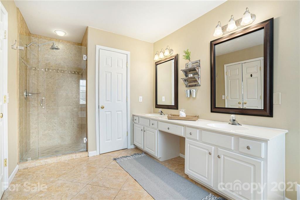 9379 Hillston Ridge Road Huntersville, NC 28078 - Photo 27 of 38 a bathroom with a double vanity sink mirror and shower