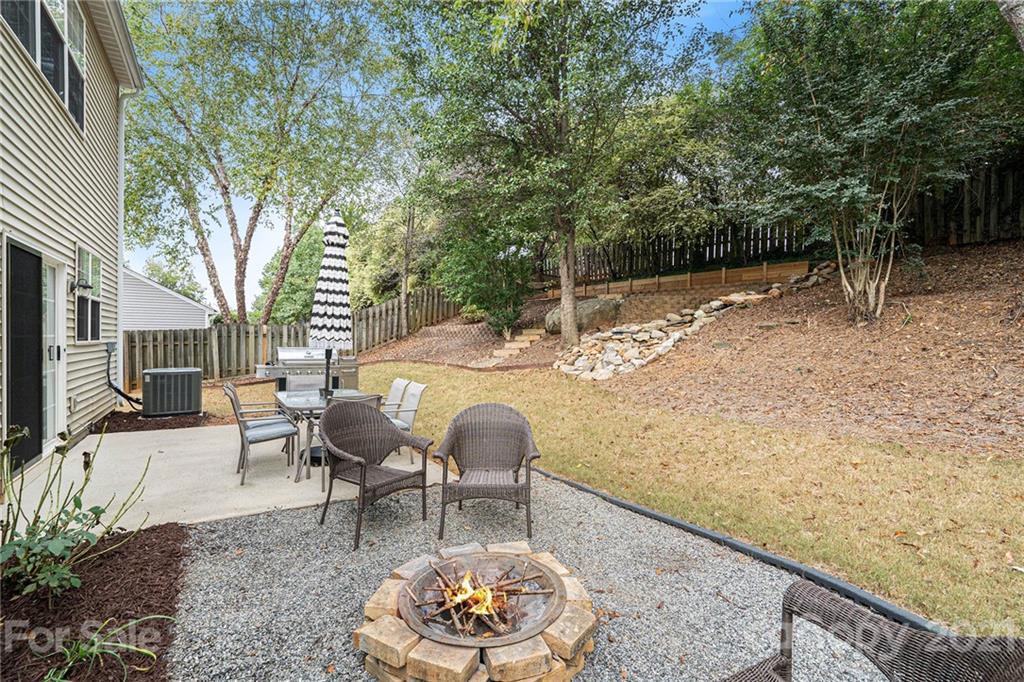 9379 Hillston Ridge Road Huntersville, NC 28078 - Photo 28 of 38 a backyard of a house with table and chairs