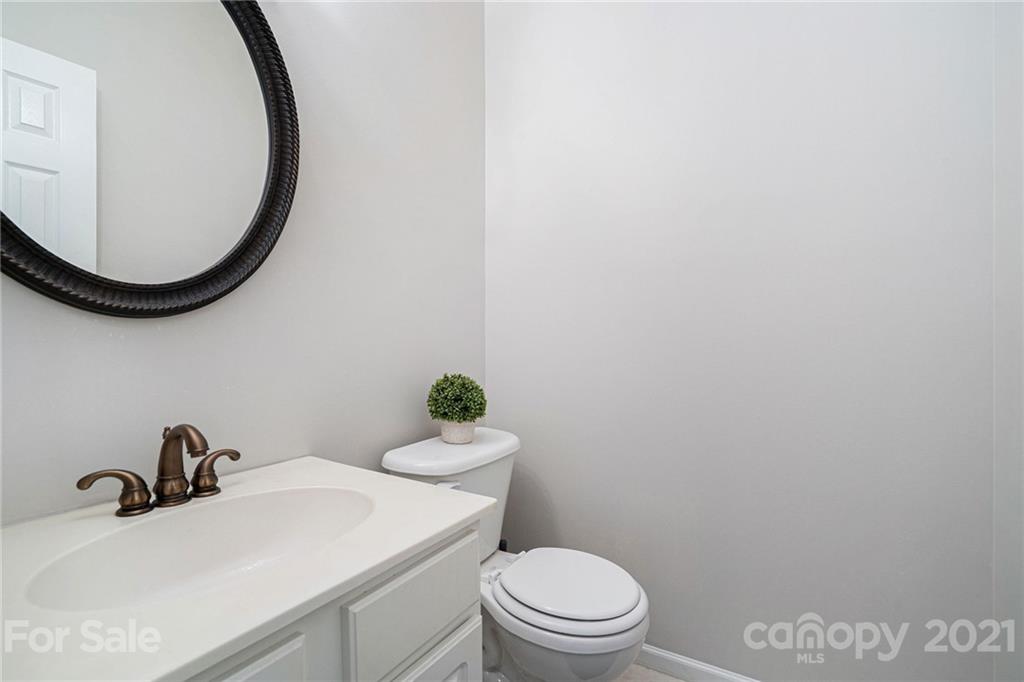 9379 Hillston Ridge Road Huntersville, NC 28078 - Photo 6 of 38 a bathroom with a sink a toilet and a mirror