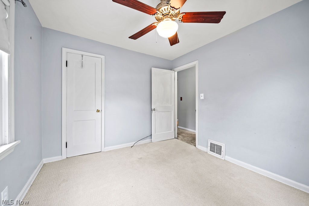 1653 Overbrook Road Cleveland, OH 44124 - Photo 7 of 29 Unfurnished bedroom featuring light carpet, ceiling fan, and a closet