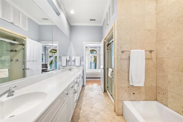 a spacious bathroom with a tub sink and mirror