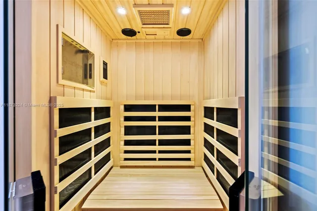 a view of a balcony with wooden floor and fence