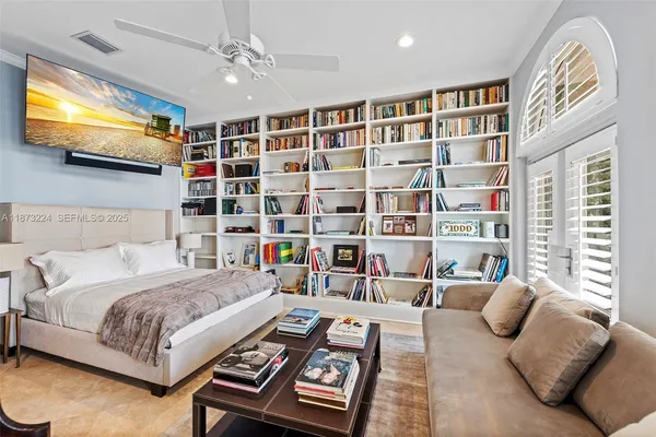 a bedroom with a bed furniture and a flat screen tv
