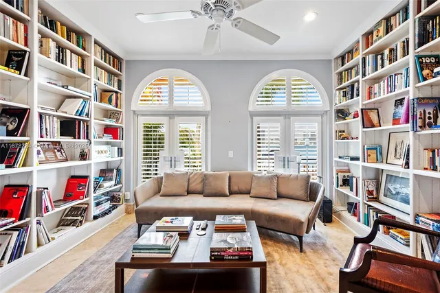 a living room with furniture and a book shelf