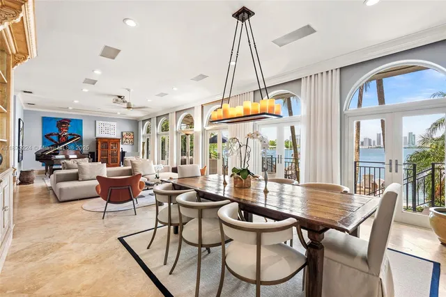 a dining room with furniture a chandelier and wooden floor