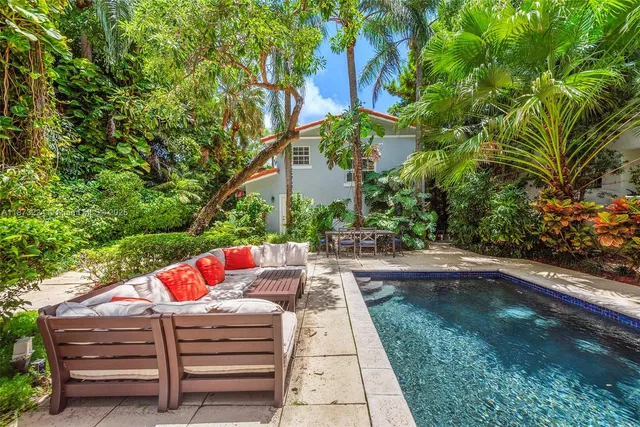 a backyard of a house with outdoor seating
