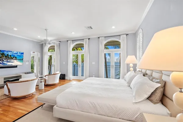 a spacious bedroom with a large bed and a large window