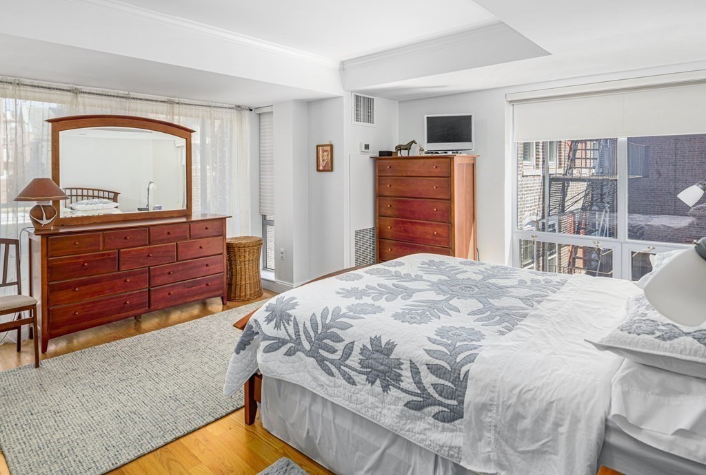 44 Prince Street, Unit 412 Boston, MA 02113 - Photo 13 of 19 a bedroom with a bed and a dresser
