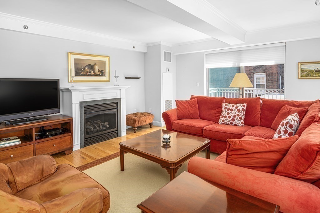 44 Prince Street, Unit 412 Boston, MA 02113 - Photo 3 of 19 a living room with furniture and a flat screen tv