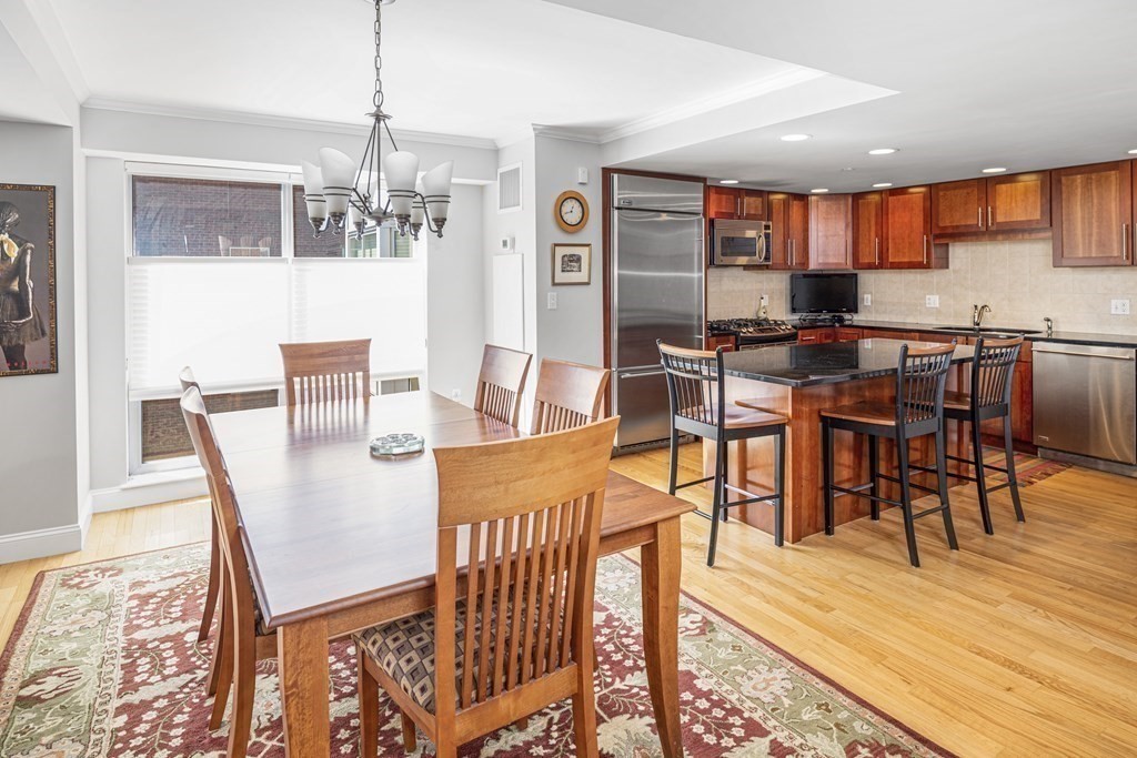 44 Prince Street, Unit 412 Boston, MA 02113 - Photo 5 of 19 a view of a dining room with furniture and wooden floor