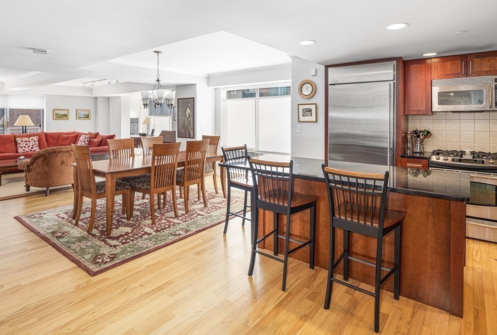 44 Prince Street, Unit 412 Boston, MA 02113 - Photo 9 of 19 a large kitchen with a table and chairs