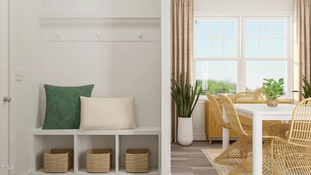 a dining room with furniture and a window