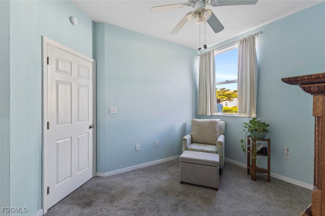 15430 Bellamar Circle, Unit 3014 Fort Myers, FL 33908 - Photo 12 of 20 a hallway with a couch and a chandelier