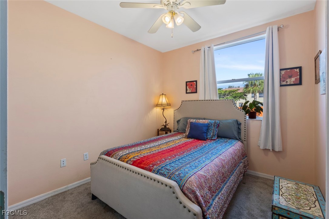 15430 Bellamar Circle, Unit 3014 Fort Myers, FL 33908 - Photo 13 of 20 a bedroom with a bed and a chandelier