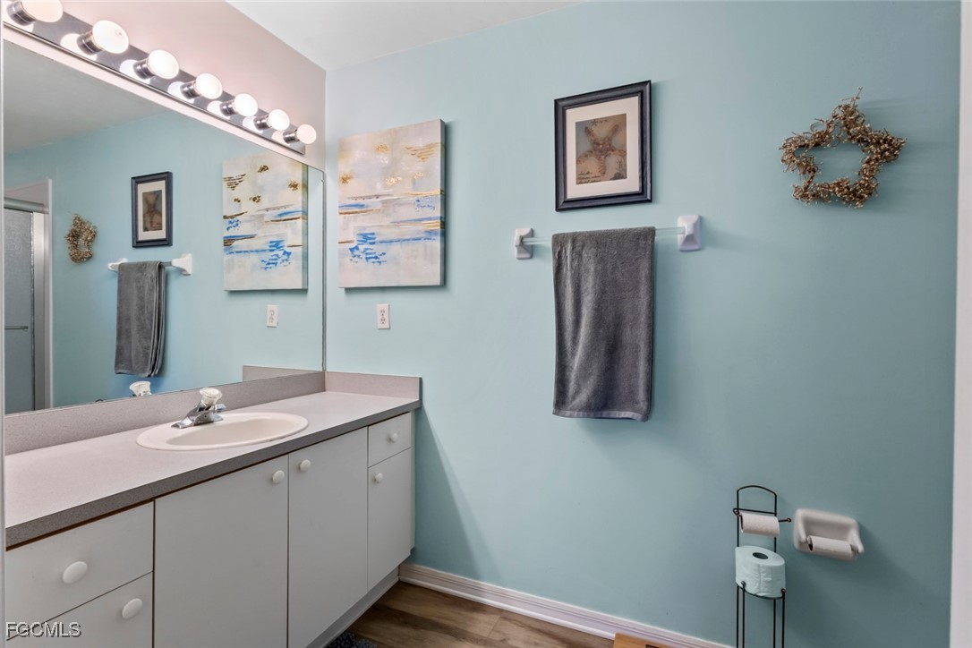 15430 Bellamar Circle, Unit 3014 Fort Myers, FL 33908 - Photo 15 of 20 a bathroom with a double vanity sink and a mirror
