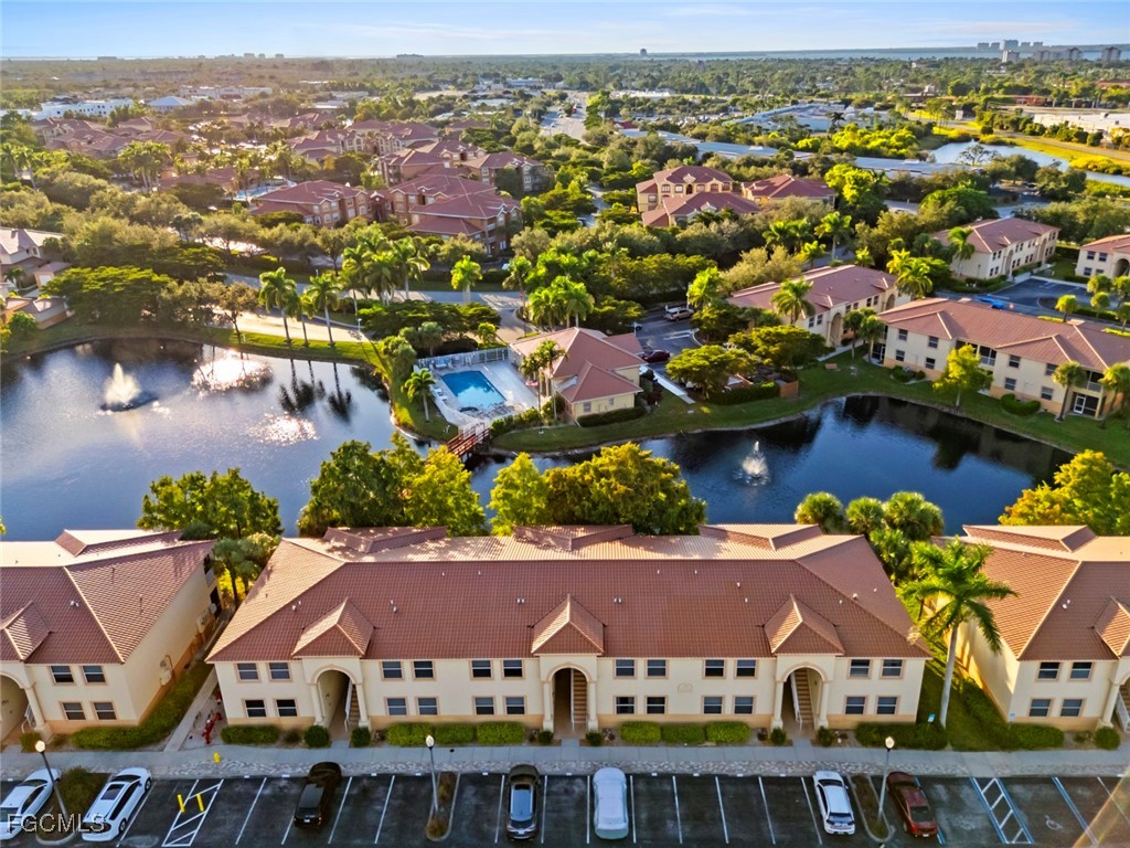 15430 Bellamar Circle, Unit 3014 Fort Myers, FL 33908 - Photo 18 of 20 an aerial view of residential houses with outdoor space and trees