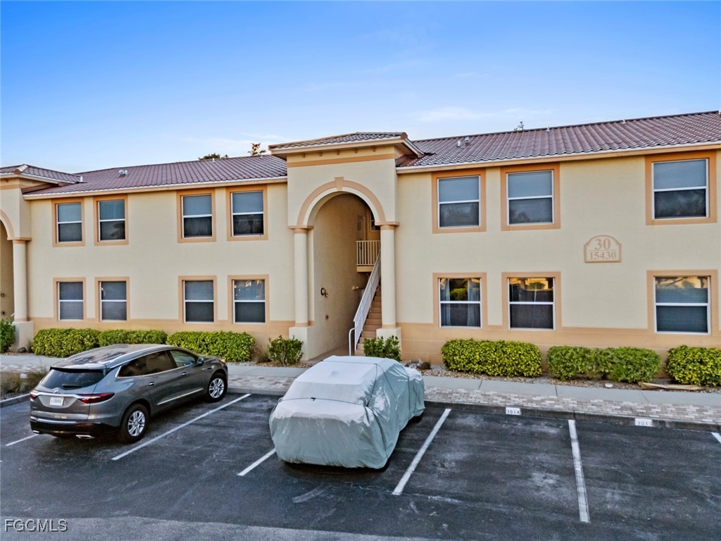 15430 Bellamar Circle, Unit 3014 Fort Myers, FL 33908 - Photo 20 of 20 a front view of a house with parking space