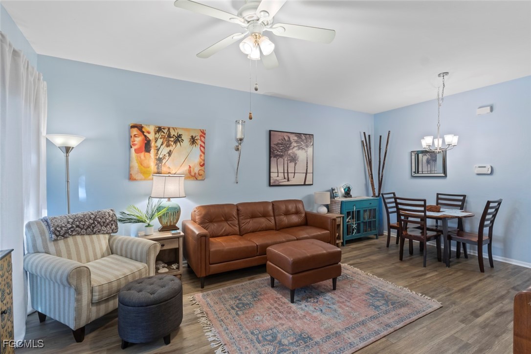 15430 Bellamar Circle, Unit 3014 Fort Myers, FL 33908 - Photo 9 of 20 a living room with furniture a desk and chair with wooden floor