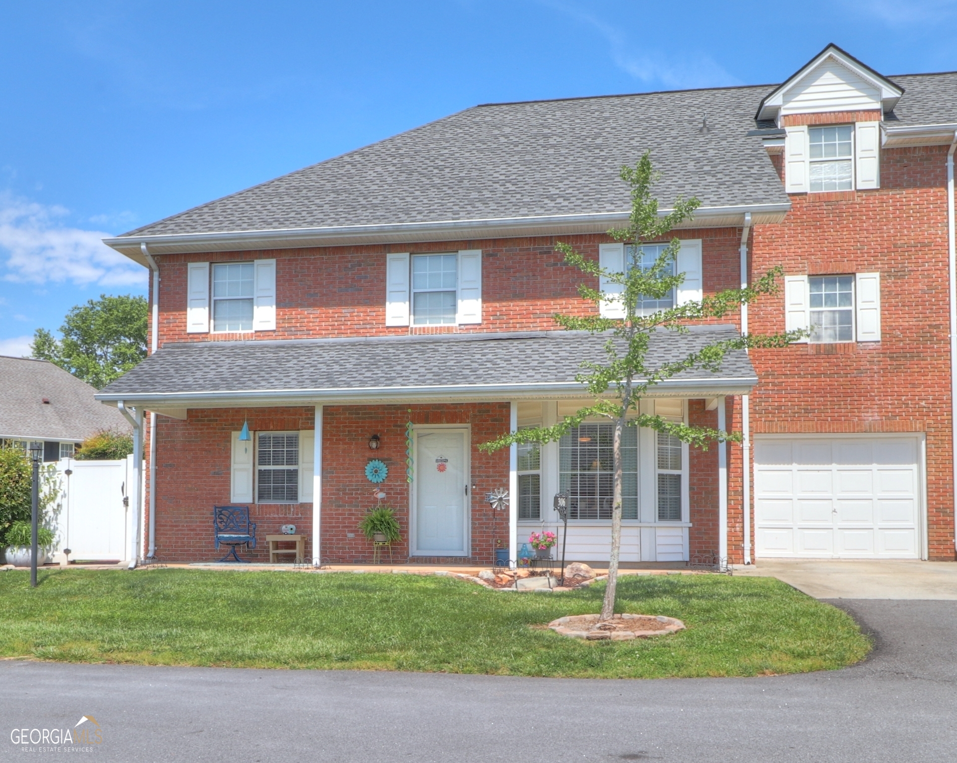306 Alston Ridge Drive, Unit 306 Cornelia, GA 30531 - Photo 1 of 1 a front view of a house with a yard and garage