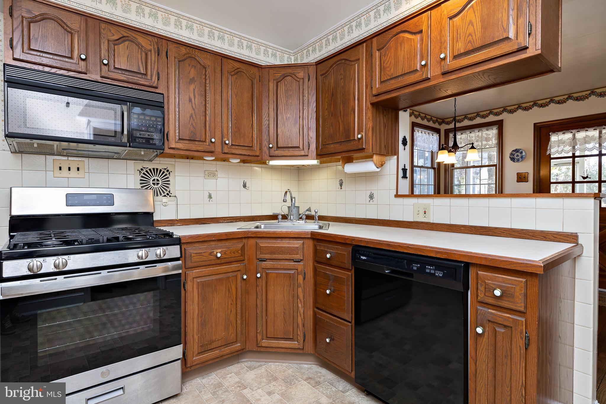 408 Yale Road Haddonfield, NJ 08033 - Photo 12 of 29 a kitchen with stainless steel appliances granite countertop a stove microwave and cabinets
