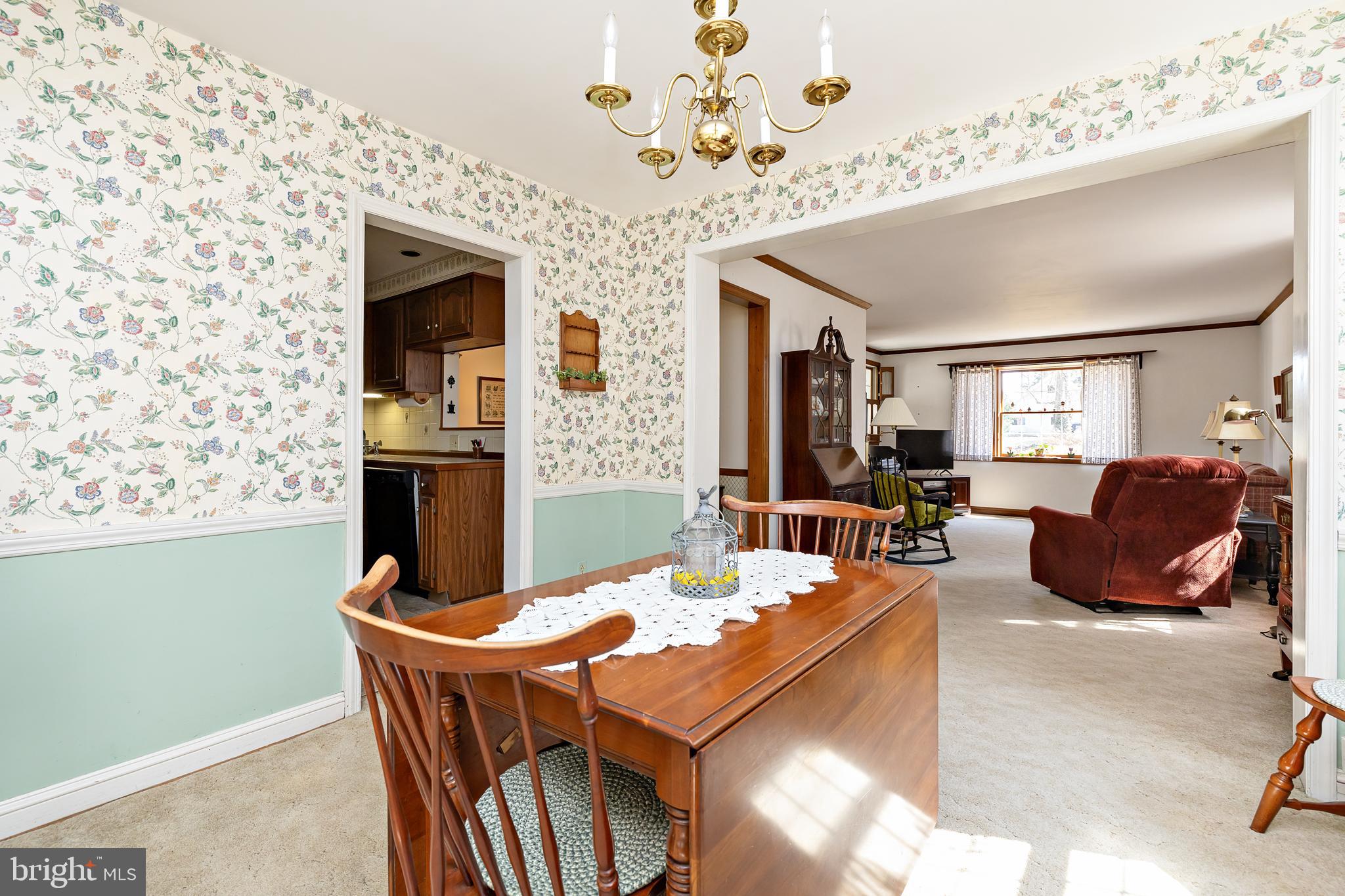 408 Yale Road Haddonfield, NJ 08033 - Photo 8 of 29 a living room with fireplace furniture and a chandelier