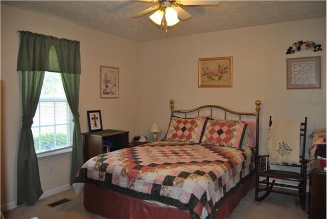 9575 Powells Chapel Road Murfreesboro, TN 37129 - Photo 9 of 18 a bed sitting in a bedroom next to a window