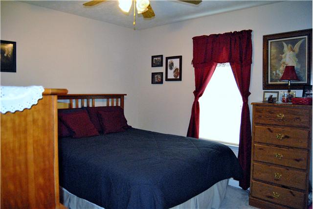 9575 Powells Chapel Road Murfreesboro, TN 37129 - Photo 10 of 18 a bed sitting in a bedroom next to a window
