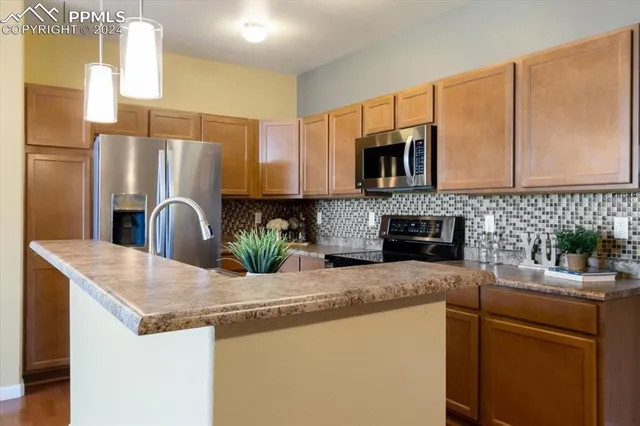 a kitchen with sink and view of living room