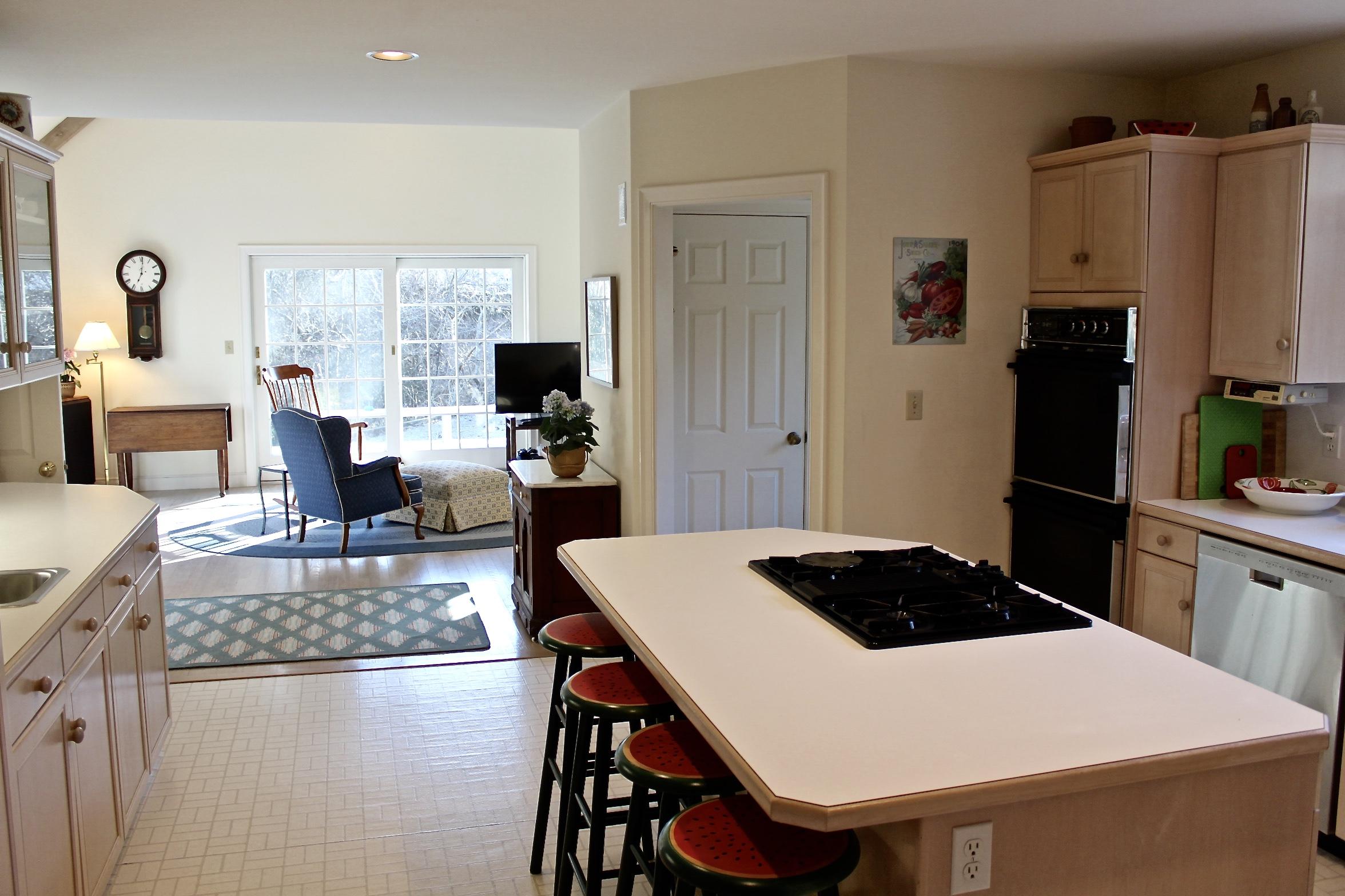 70 Eel River Road Osterville, MA 02655 - Photo 14 of 27 a kitchen with a table chairs refrigerator and wooden floor