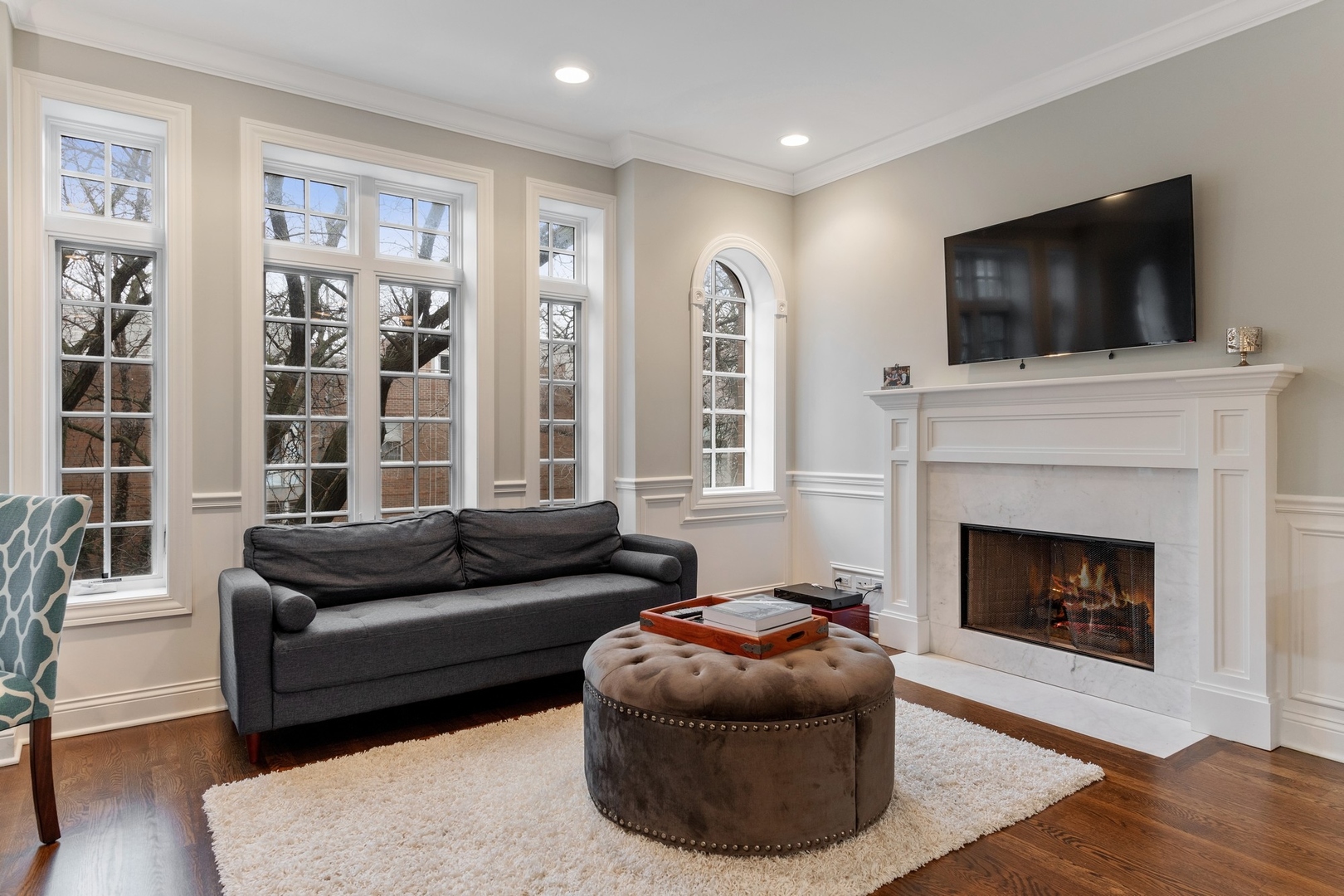 2019 North Racine Avenue, Unit 2 Chicago, IL 60614 - Photo 2 of 14 a living room with furniture a flat screen tv and a fireplace