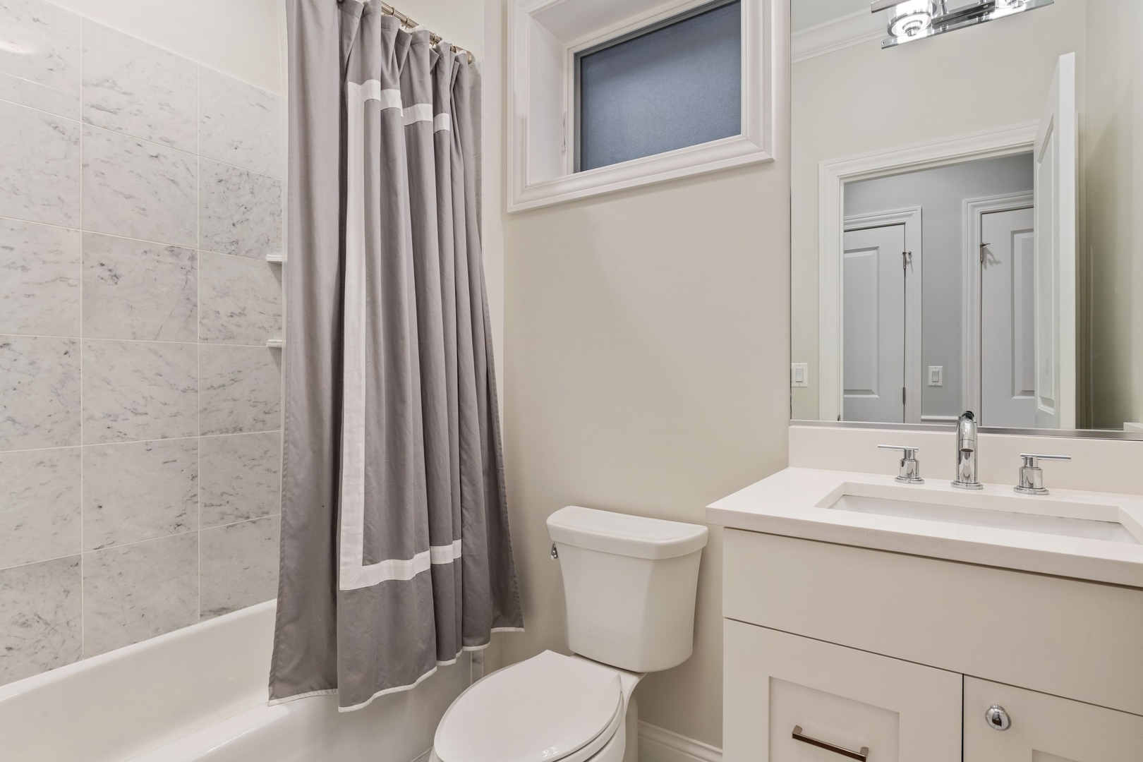 2019 North Racine Avenue, Unit 2 Chicago, IL 60614 - Photo 11 of 14 a bathroom with a sink a toilet a mirror and shower