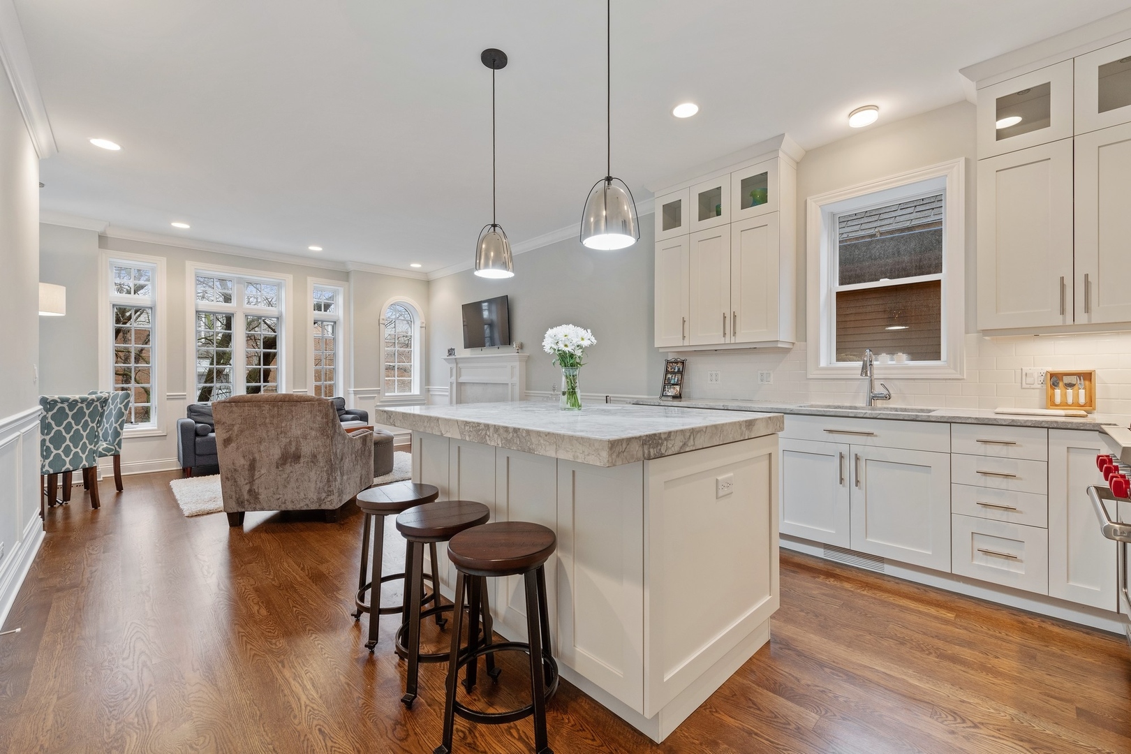 2019 North Racine Avenue, Unit 2 Chicago, IL 60614 - Photo 4 of 14 a open kitchen with kitchen island granite countertop wooden floors and white cabinets