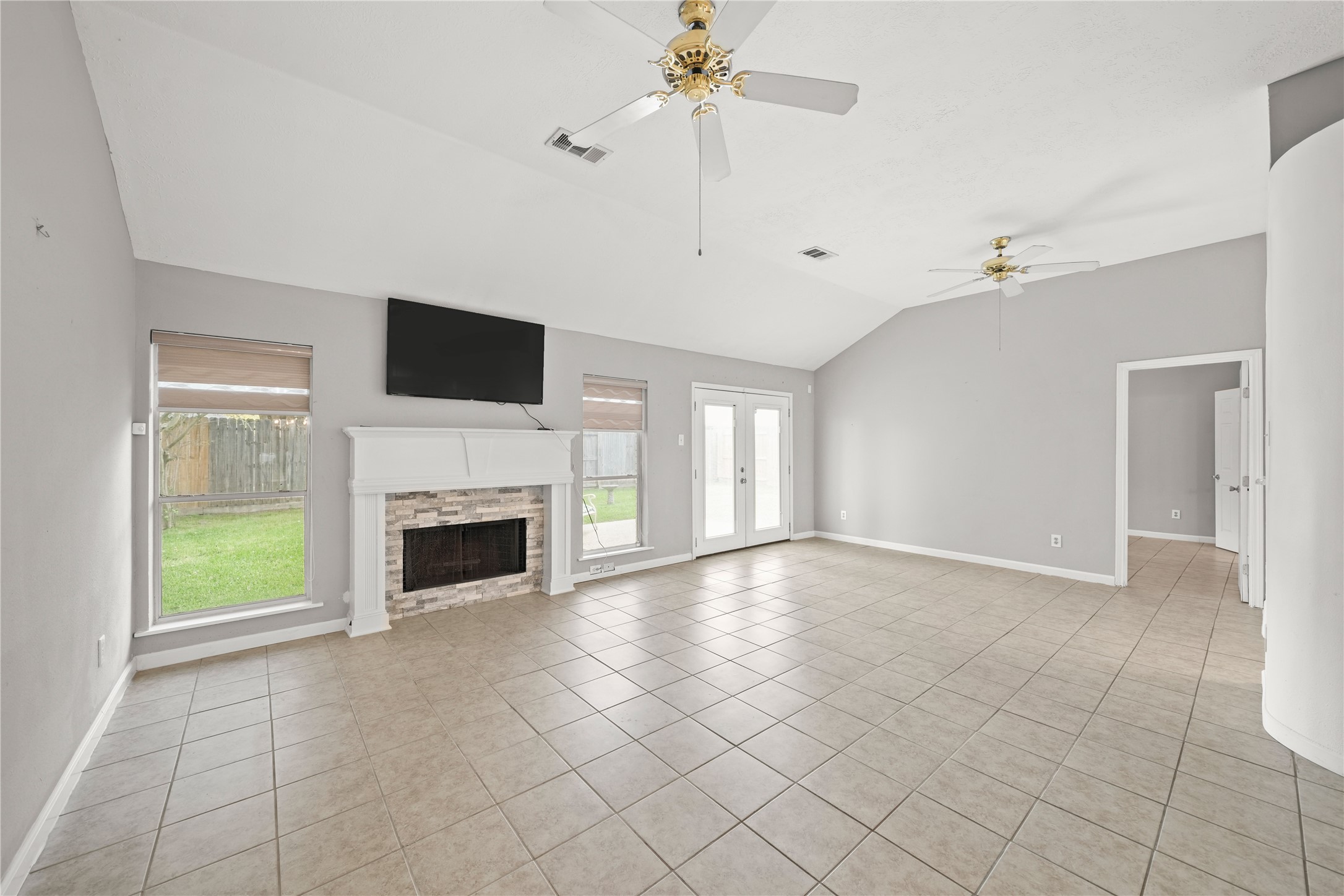 8134 Blue Jay Street Baytown, TX 77523 - Photo 9 of 31 Custom trim and updated ceiling fans enhance this relaxing living space, creating the perfect place to unwind after a long day. The fireplace-mounted television will convey with the home, courtesy of the seller.
